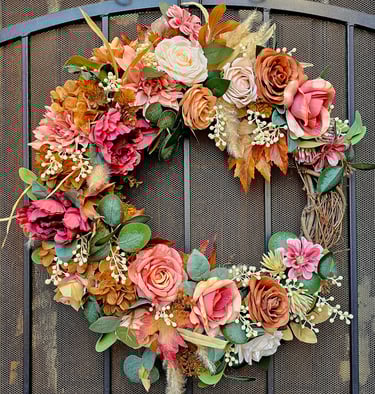 Luxury permanent botanical autumn wreath with terracotta roses, peonies, and fall foliage on a grapevine frame
