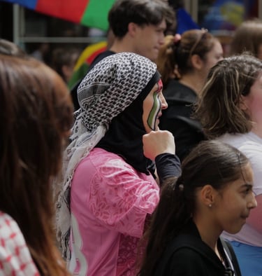 a woman in a pink jacket talking on a cell phone