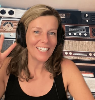 emma scott with headphones displaying the peace sign radios in the back ground 