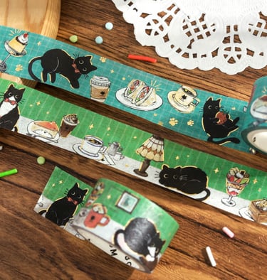 Green decorative washi tape featuring illustrations of black cats and cafe food for scrapbooking.