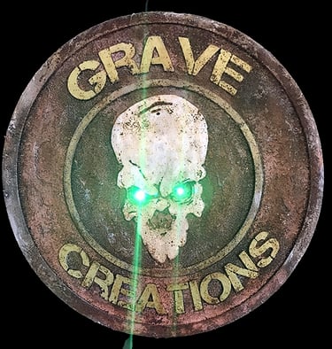 a green light shining through a grave stone plaque
