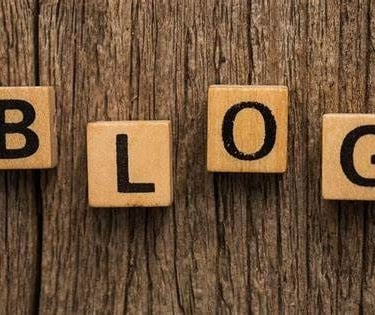 Polished wooden blocks with letters written on it forming the word blog