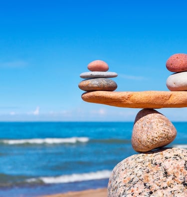 a stack of rocks balancing on a beach