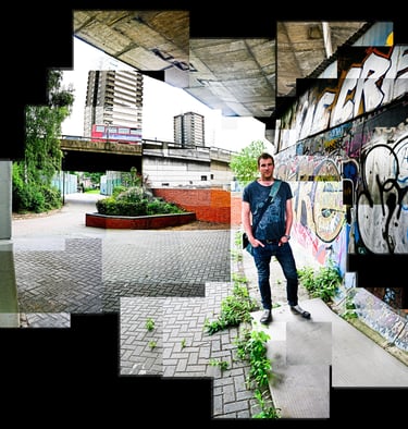 A joiner of a person standing next to a wall with graffiti sprayed on it in the inner city