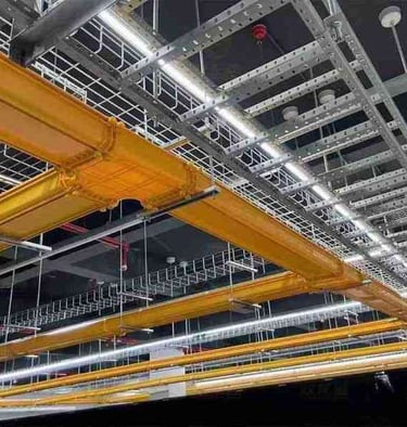 a ceiling with fiber cable trays and wire mesh cable tray and a ceiling light