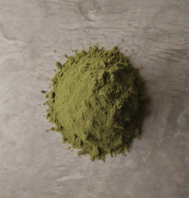 Fresh green tea leaves arranged neatly on a light khaki cloth.