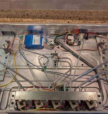 ge monogram cooktop the inside view - spark module and transformer