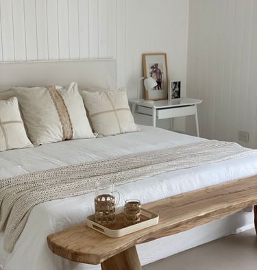 a bed with a wooden bench and a wooden bench with a wooden bench and a