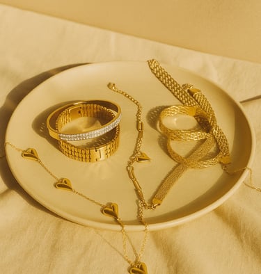 a plate with a gold bracelet bracelets and a gold bracelet. aesthetic, old money aesthetic, vintage