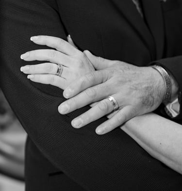 black and white image of hands with wedding rings