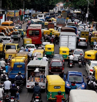 traffic chaos of rickshaws and buses on a road