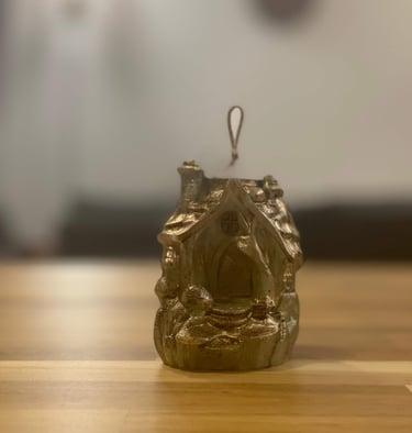 a small house with a small statue of a man