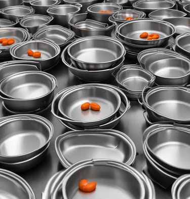a stack of stainless steel frying pans with spoons and spoons
