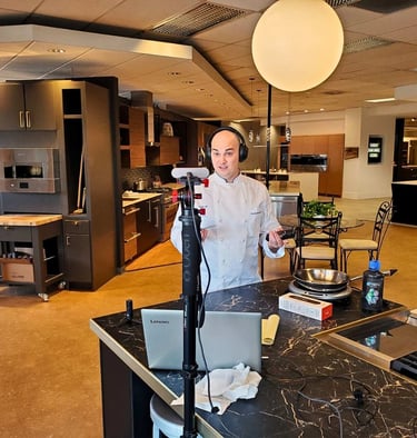 Chef Andrew Forlines in a retail home kitchen appliance showroom recording a video podcast episode.