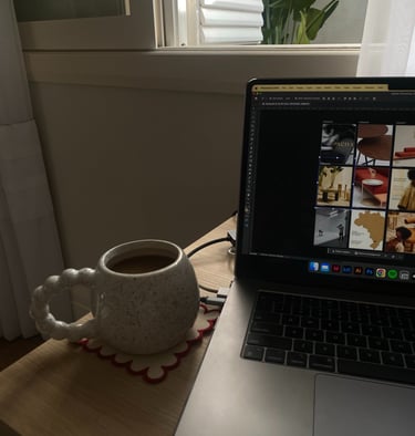 a laptop computer sitting on a table with a cup of coffee