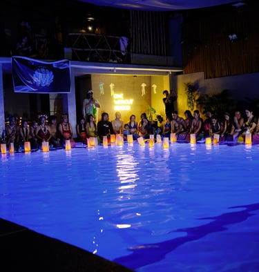 mermaid event at night in beautifully lit swimming pool with Asian lanterns