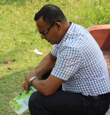a man sitting on a bench in a park