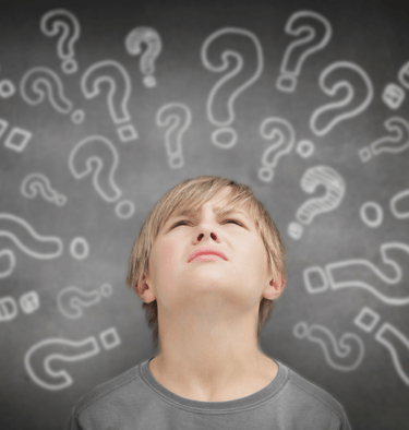 Confused boy with question marks around his head, representing ADHD processing challenges