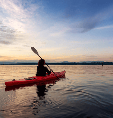 a person in a red kayak is in the water