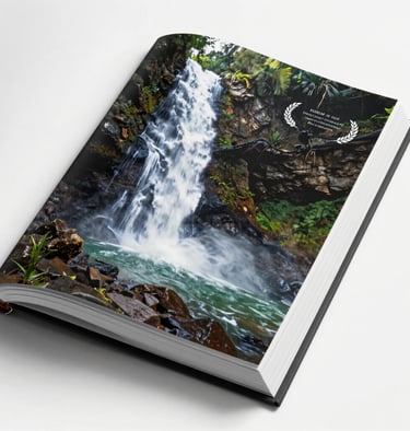 A high-quality open book showcasing a professional photo of a hidden waterfall. The page edges are crisp and clean. Natural lighting.