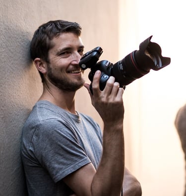 a man holding a camera and taking a picture