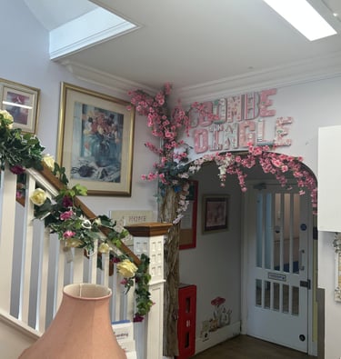 bright entrance hall with flowers along the stairs