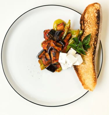Vegetables with grated tomatoes served with feta cheese and bread- a dish by Villa Eats in Naxos 