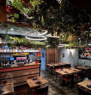 a restaurant with a large amount of plants and a bar