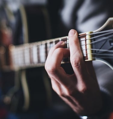 a man playing guitar in a room
