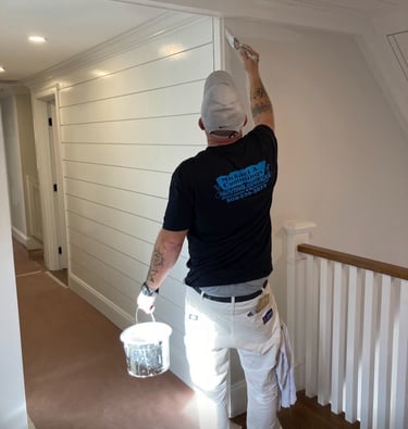 Michael Cummings painting interior walls in Duxbury, MA home using professional brushstrokes