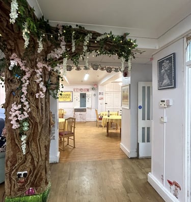 open lounge and dining area with a feature tree decorating the space