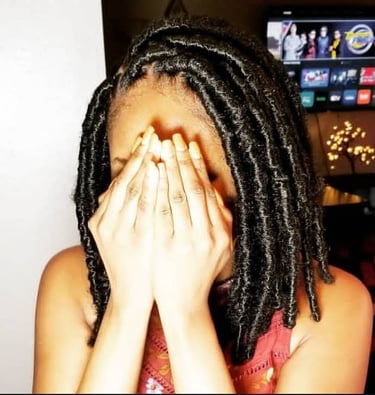 a woman with a large black butterfly locs