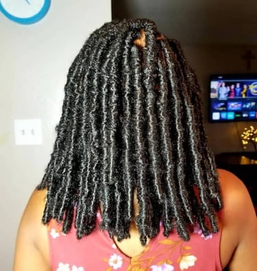 a woman with a large black butterfly locs