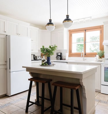 a kitchen with a large island and a white refrigerator