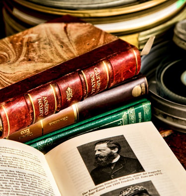 stack of books with film reel