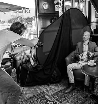 a man in a suit and tie is taking a photo of a man in a