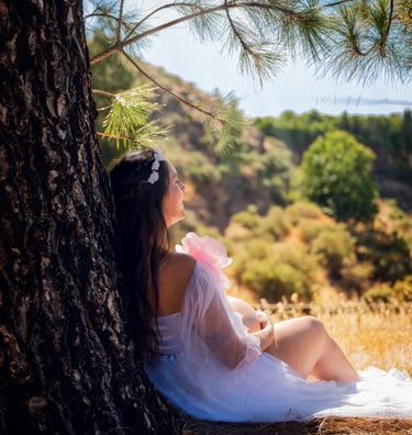 a woman sitting on a tree trunk trunk trunk trunk trunk trunk trunk trunk trunk trunk
