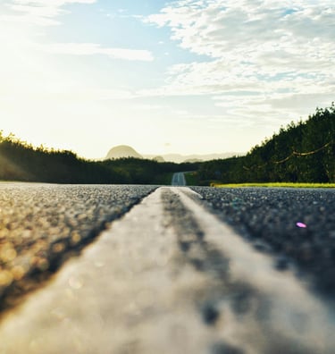 A Long road with text reading "Road Trips" linking to a page with road trips from Texas.
