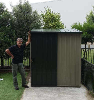 Handy man leaning on Garden Shed