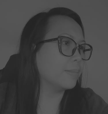 Profile of Jocelyn Batulan with long dark hair wearing stylish black eyeglasses in portrait.