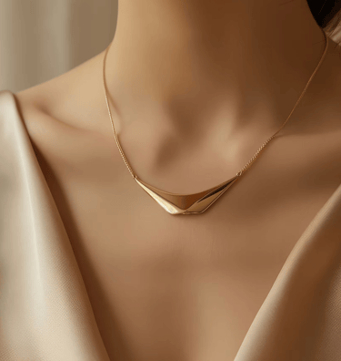 a woman's neck wearing a gold necklace with a gold plated necklace
