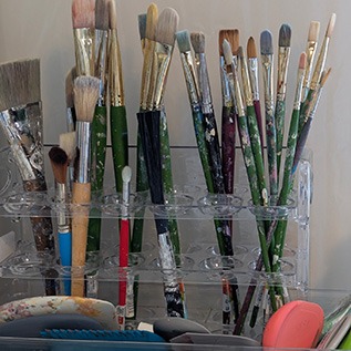 Stand with many artists paintbrushes