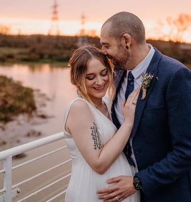 a bride and groom look happy pictured on the top deck of the ark northampton at sunset