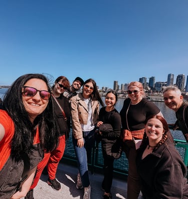 team on the ferry to Bainbridge Island with the Seattle skyline in the background during a team retr