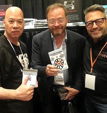RayRay Lum and Brett Barry  holding magic trick products like Colors in Mind doodle pad.