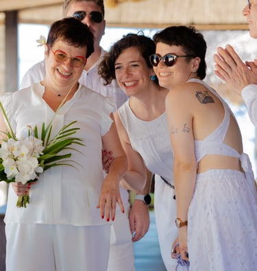 a group of people standing around a woman in a white dress