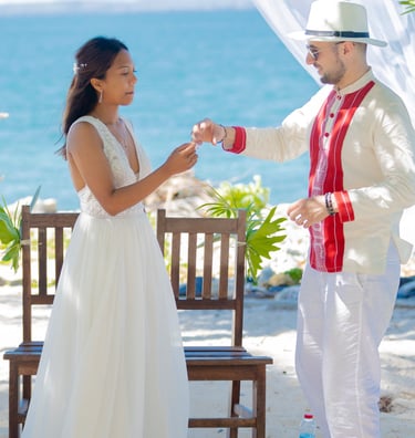 a man and woman standing in front of a white tent