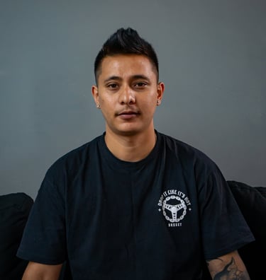 Kiron creating a custom tattoo at Royal Nine Tattoo, showcasing precision linework and tattoo