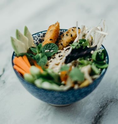 culinary tasty healthy bowl of food with coated fish fingers and fresh vegetables
