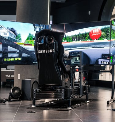 A Motion Sim Racing Simulator With 3 55" TV's. Motion Simulator Is Produced By D-Box